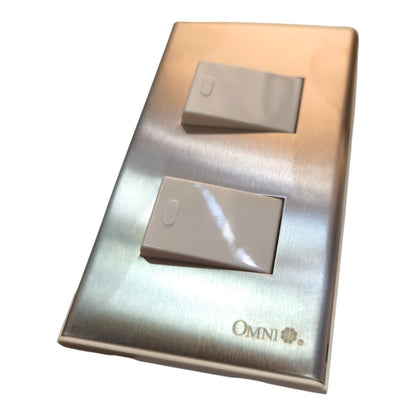 A two-light switch plate set in brushed stainless steel with two beige plastic rocker switches, featuring the 'OMNI' brand logo in the bottom right corner.