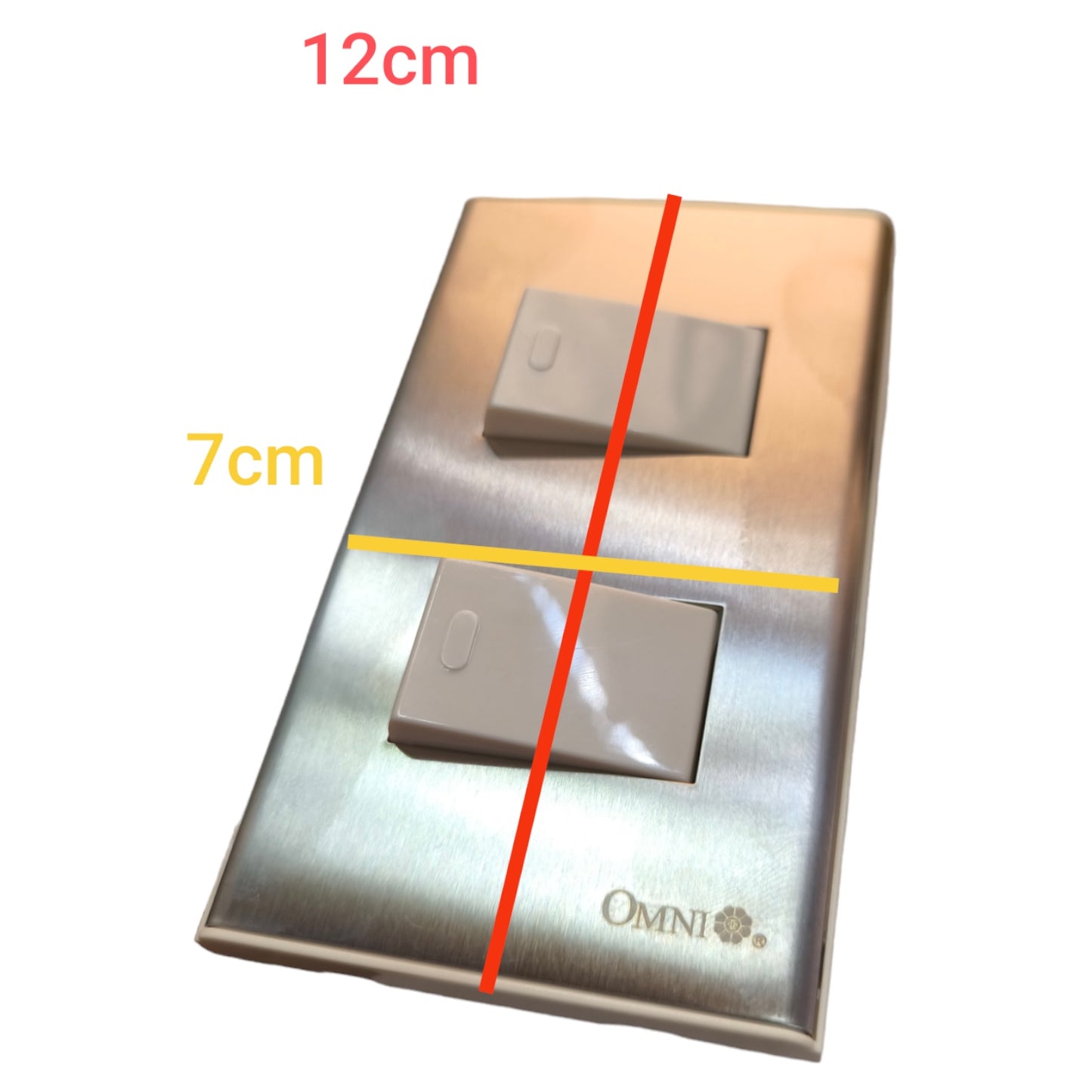 A brushed metal double light switch plate shown on a white background with red and yellow dimension lines and text indicating 12cm by 7cm measurements. The brand name OMNI is visible near the bottom.