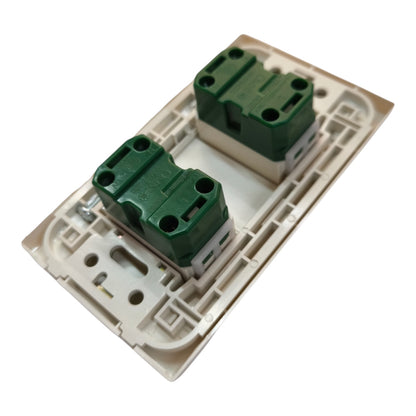 A dual-gang light switch module with two green terminal blocks set in a beige plastic backplate, shown on a plain white background.