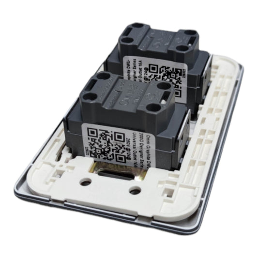 A replacement light switch module featuring two black contact relays mounted on a white plastic backplate with a silver metal edge, shown against a plain white background.