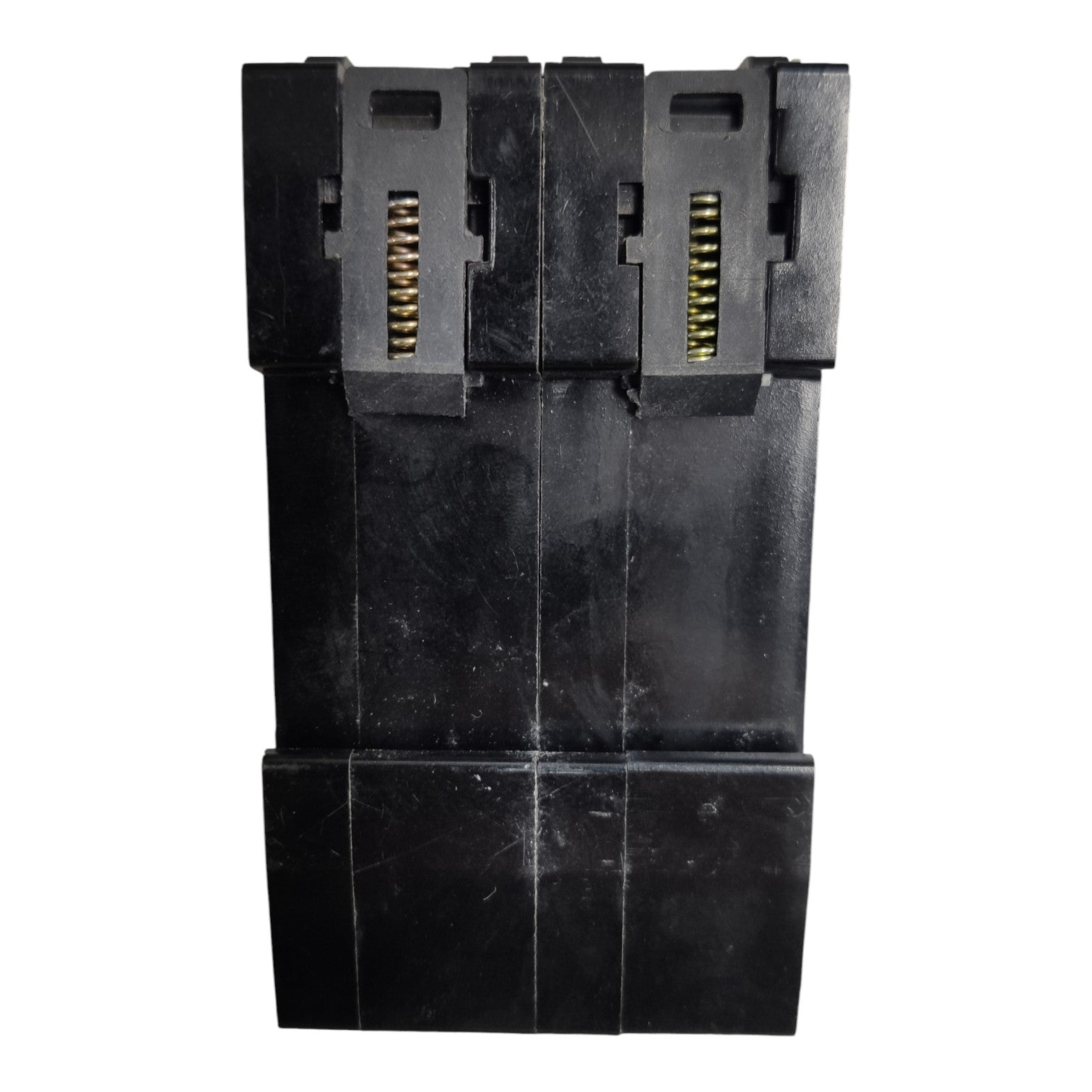A black plastic multi-connector plug or adapter component with gold-toned metal pins visible in two vertical slots, shown against a plain white background.