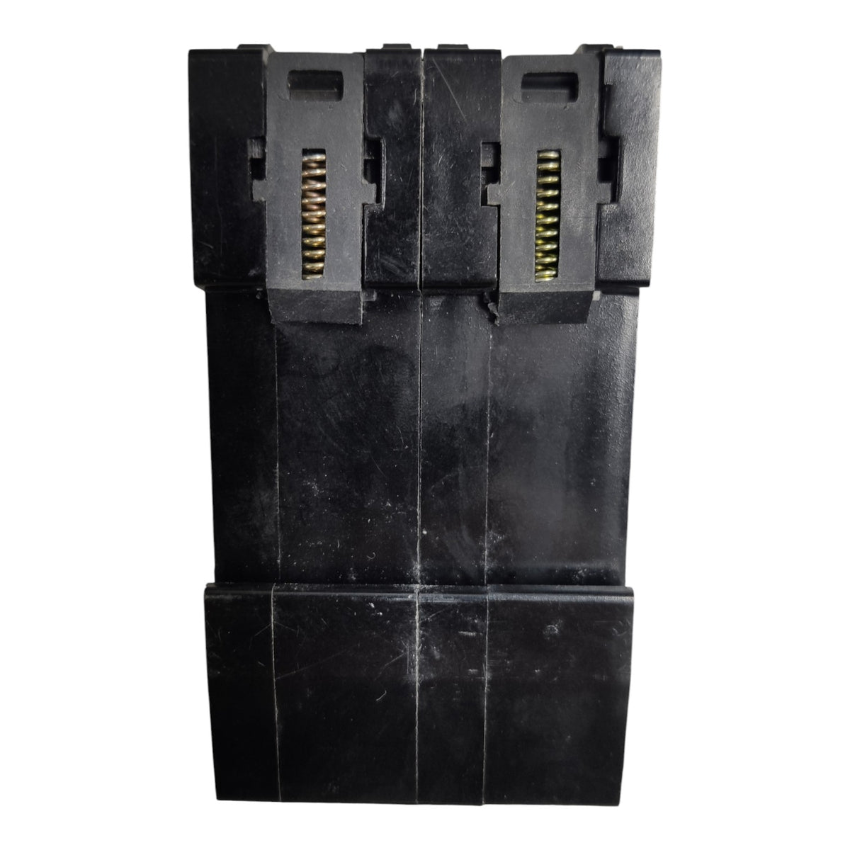 A black plastic multi-connector plug or adapter component with gold-toned metal pins visible in two vertical slots, shown against a plain white background.