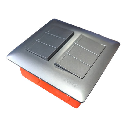A modern square dual switch plate with a brushed silver metal top and a bright orange base, shown on a plain white background.