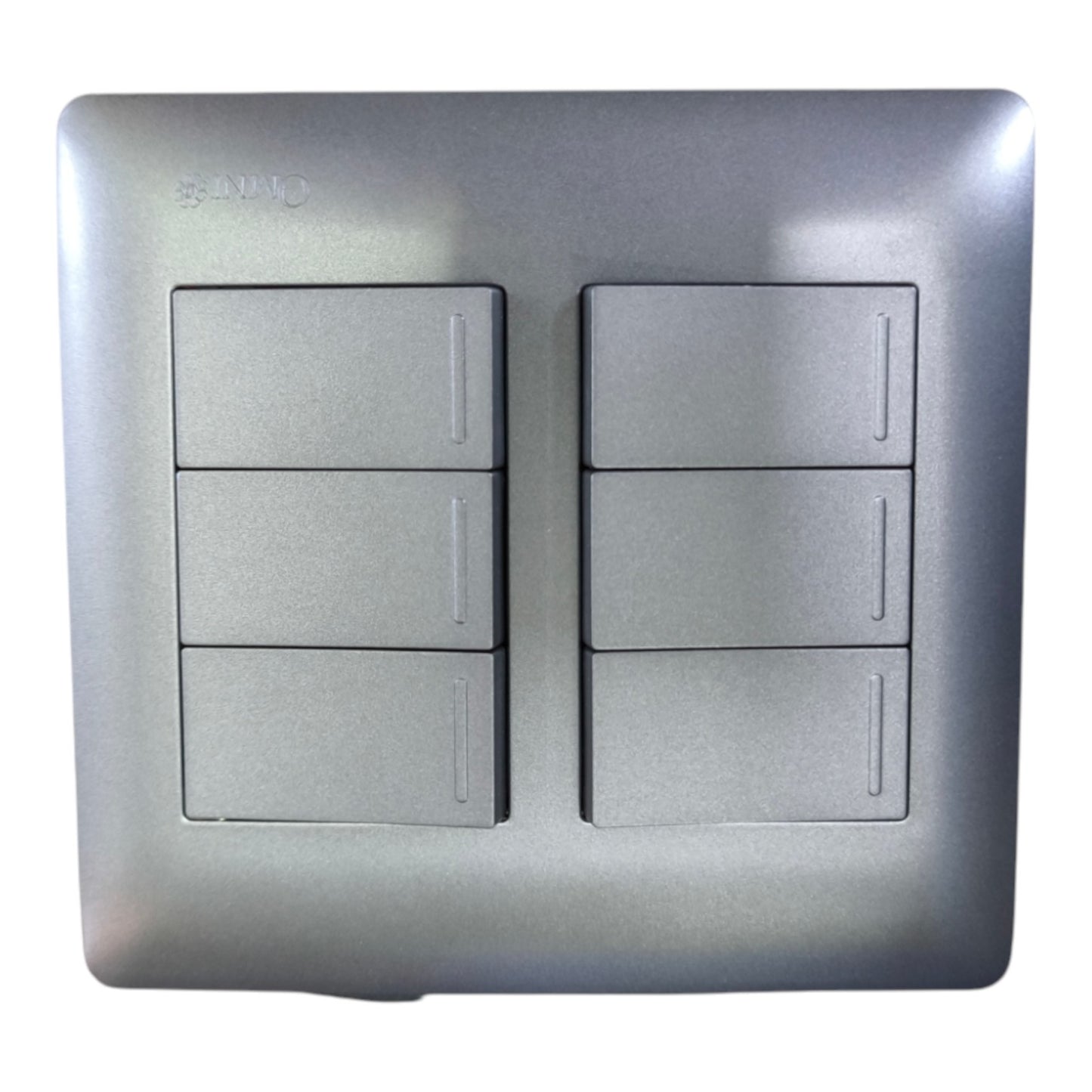 A square metallic silver 6-way light switch plate with two columns of three individual switches, featuring a brushed metal texture and a subtle brand engraving in the top left corner.