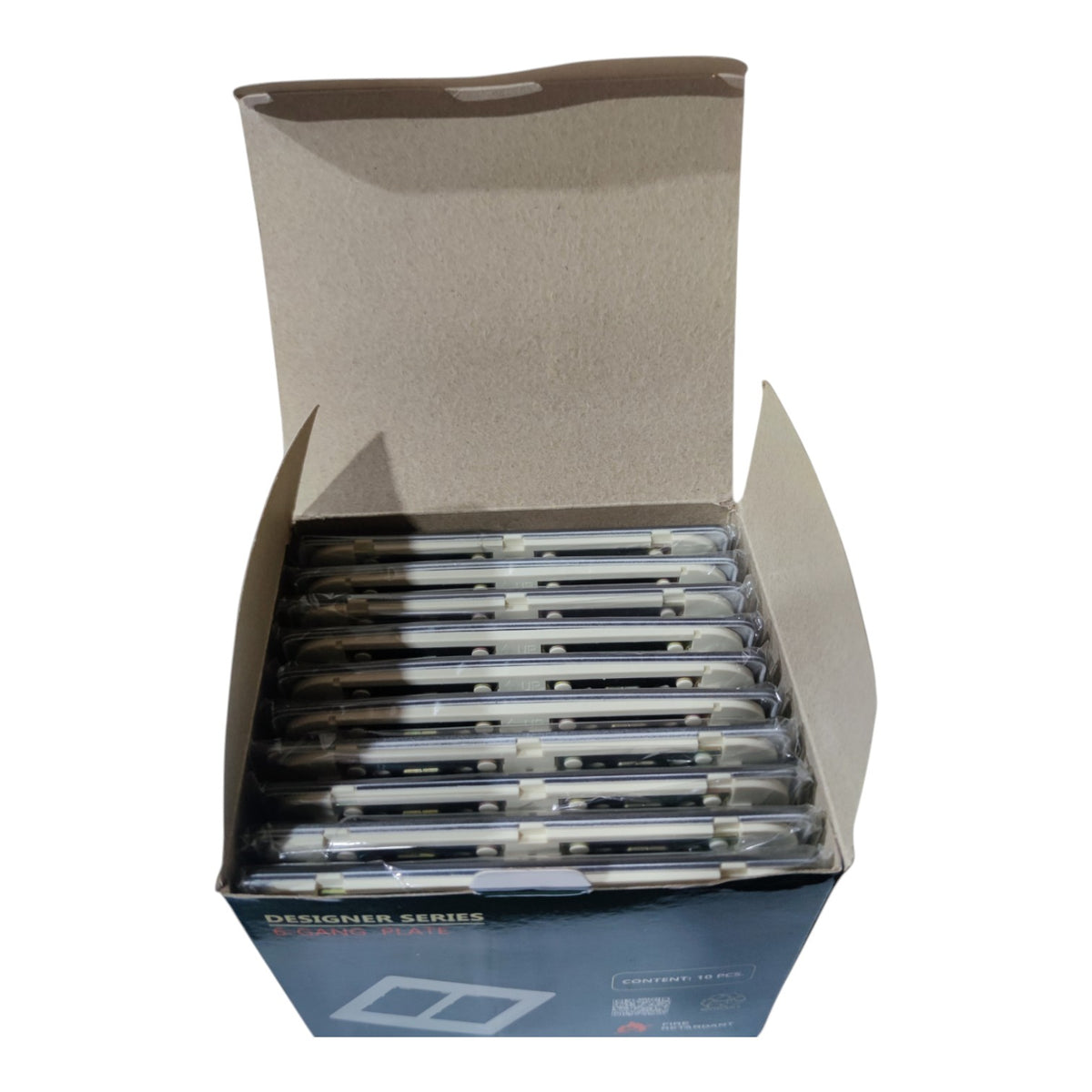 An open cardboard display box containing multiple packs of designer series ballpoint pens, photographed on a plain white background.