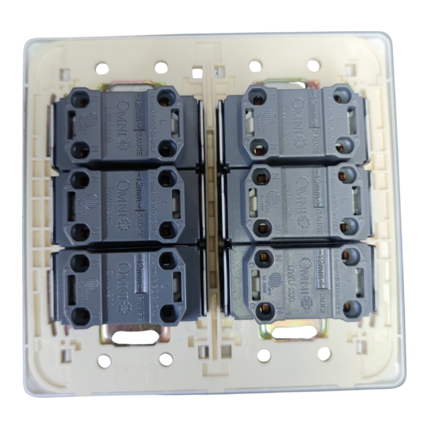 A 6-way dual 3-pin rear view of a wall switch plate featuring four dark gray contact blocks arranged in two columns of two, set against a cream-colored plastic backplate.