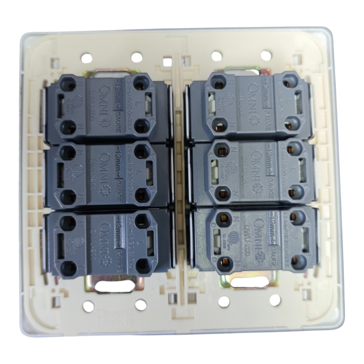 A 6-way dual 3-pin rear view of a wall switch plate featuring four dark gray contact blocks arranged in two columns of two, set against a cream-colored plastic backplate.