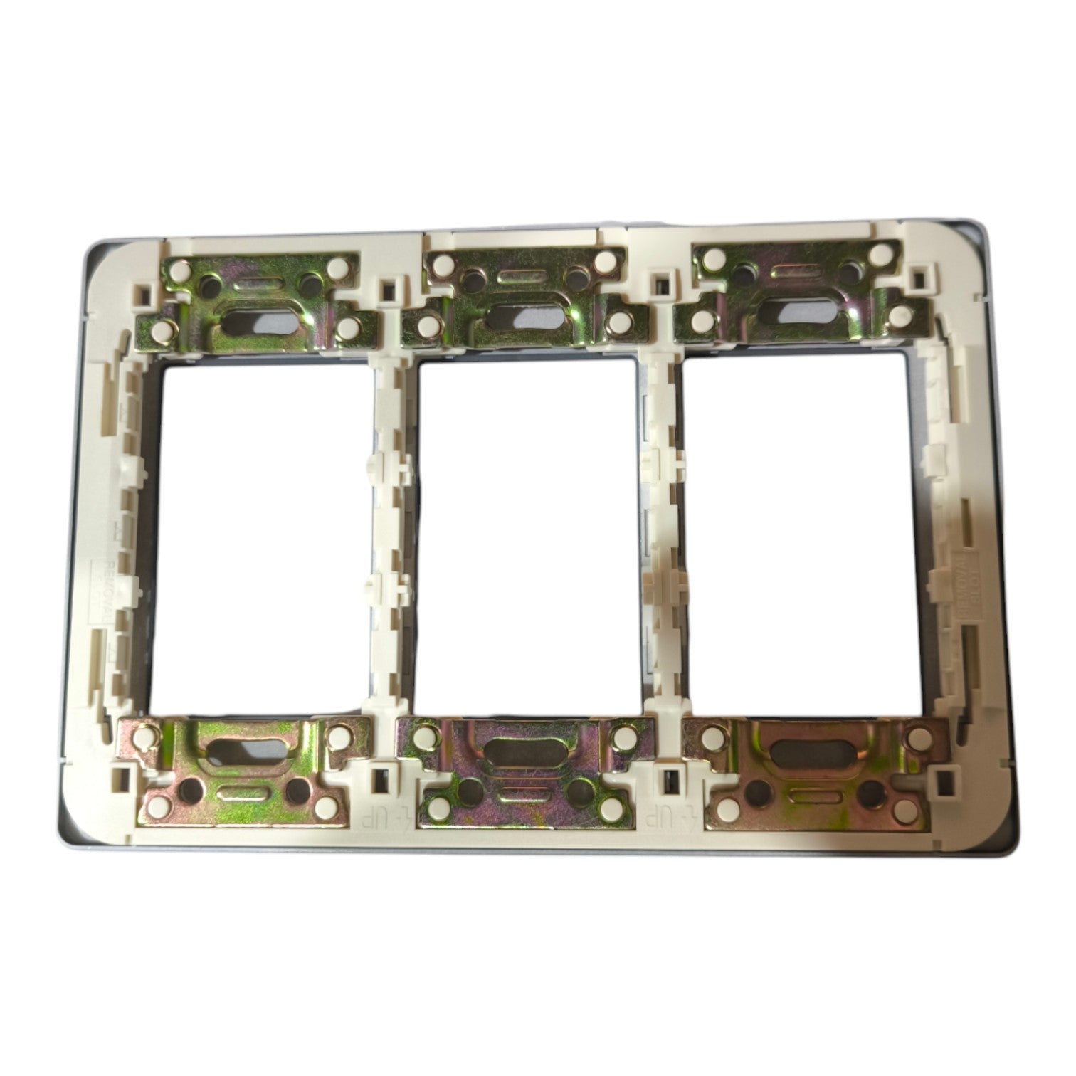 A three-gang electrical outlet plate frame with a beige plastic insert and a metallic backing showing green and gold-toned copper plating, isolated on a white background.