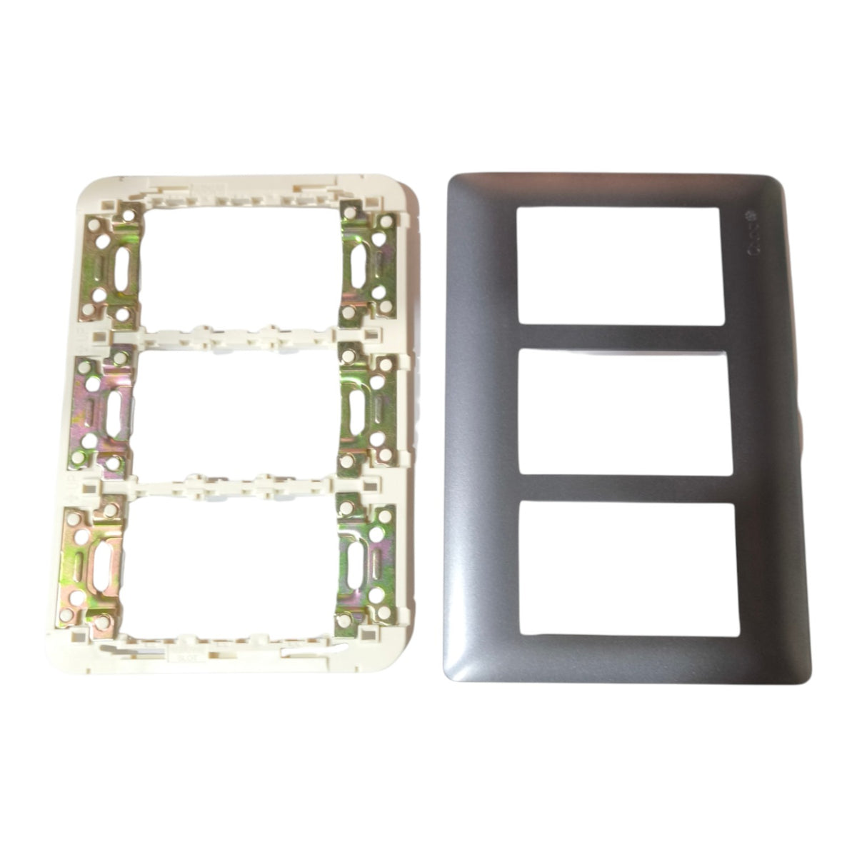 A two-piece electrical outlet cover plate set on a white background, featuring a dark gray three-toggle faceplate and its corresponding white backplate with internal metal mounting hardware.