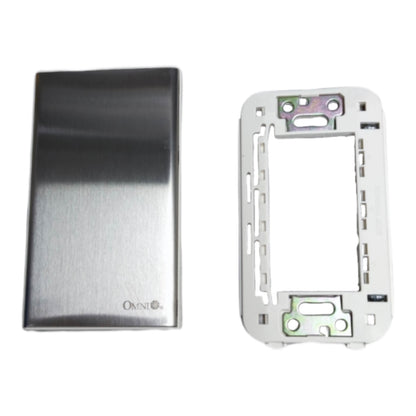 A brushed stainless steel electrical switch plate cover and its corresponding white mounting backplate, shown side-by-side on a white background. The brand name 'OKMI' is visible on the lower left of the metal cover.