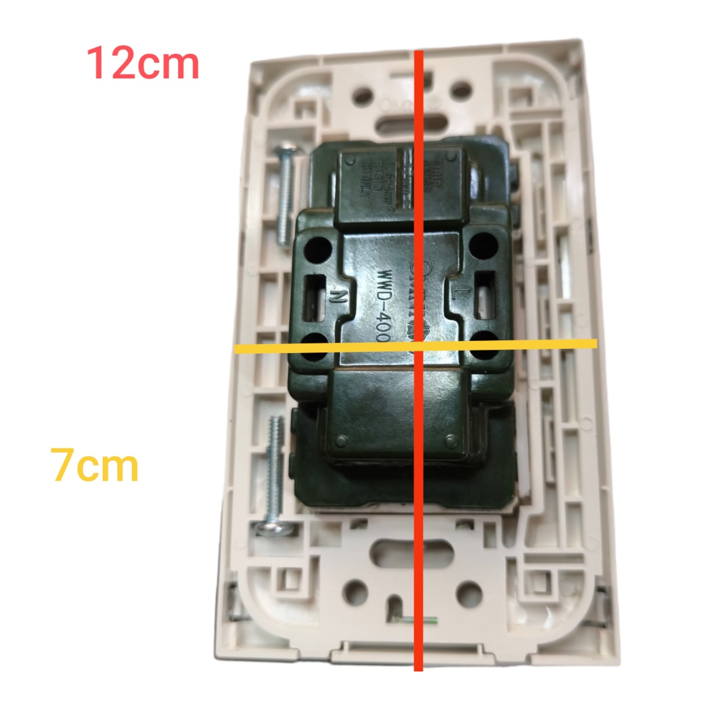 A rear view of a wall switch plate showing the back of a dark green electrical contact block mounted in a beige plastic cover, with overlaid dimension lines indicating 12cm width, 7cm height, and a vertical center line.