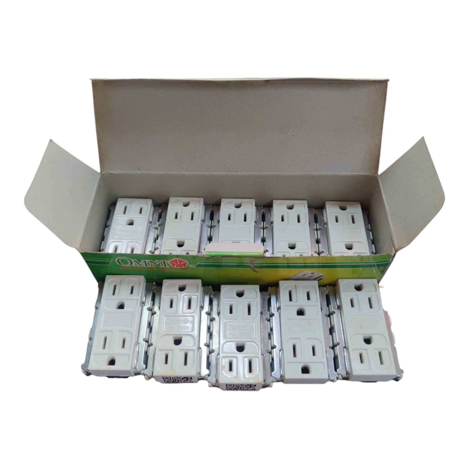 An open cardboard box containing multiple white electrical outlet covers arranged in rows, photographed on a plain white background.