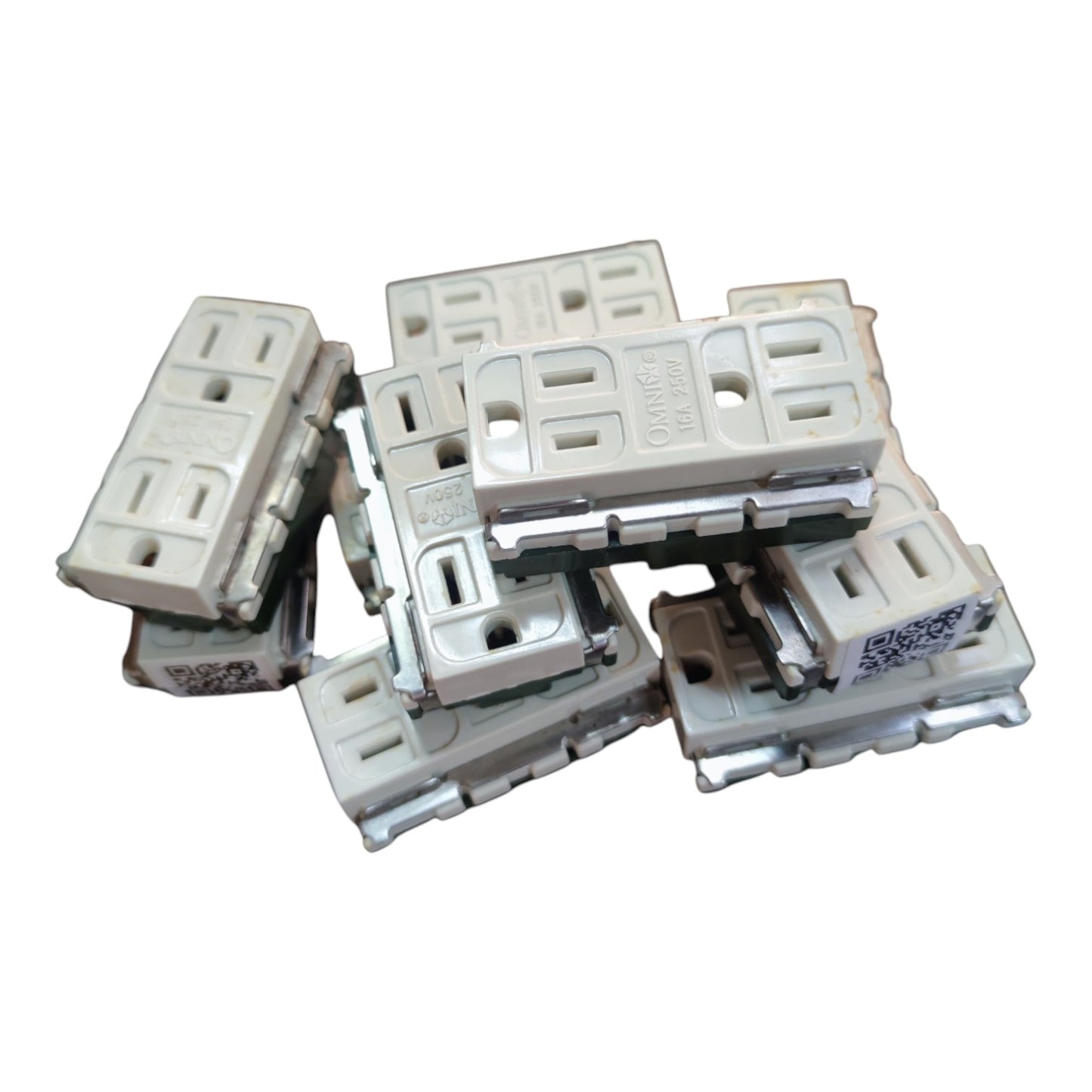 A pile of white plastic wall outlets with integrated switches, photographed on a solid white background.