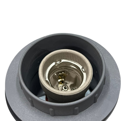 A close-up of a gray plastic socket or connector housing containing a metallic silver-toned inner contact piece, shown against a plain white background.
