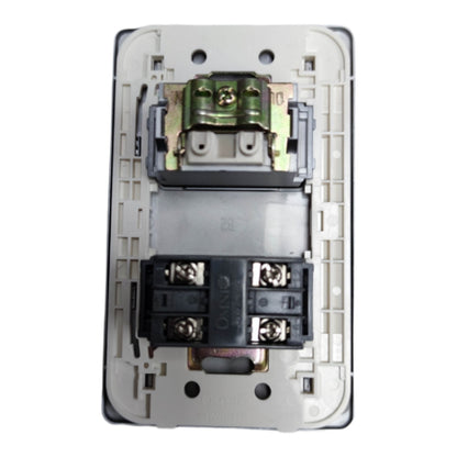 An electrical wall switch module with exposed internal components, including a green terminal block at the top and black terminal connectors at the bottom, set against a plain white background.
