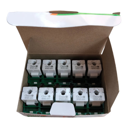 An open cardboard box containing ten small white electrical components mounted on green circuit boards, photographed against a plain white background.