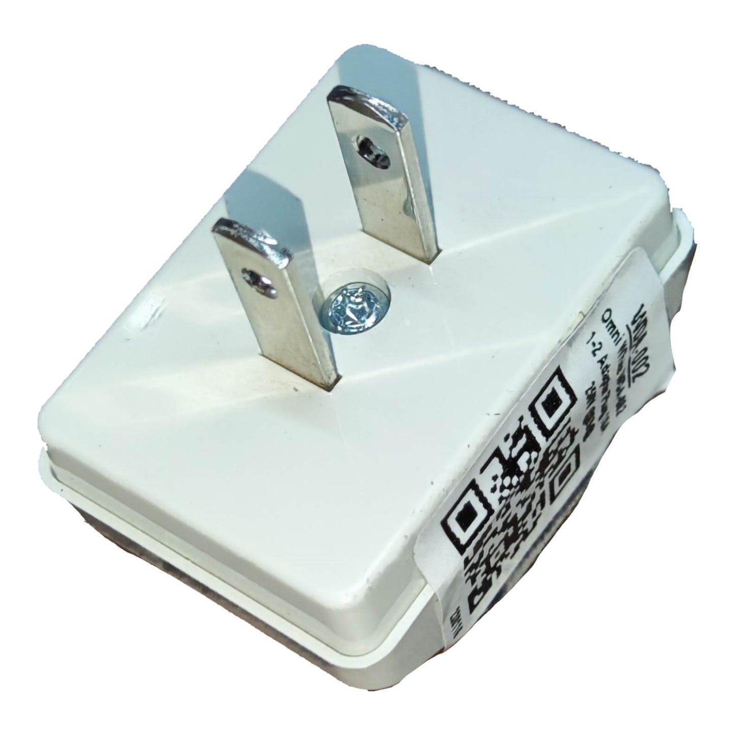 A white plastic electrical outlet adapter with two silver metal prongs and a printed label on the side, isolated on a white background.