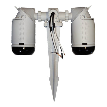 A dual outdoor security camera kit with two white dome cameras featuring black lenses, mounted on a white central bracket with a ground spike and exposed wiring.