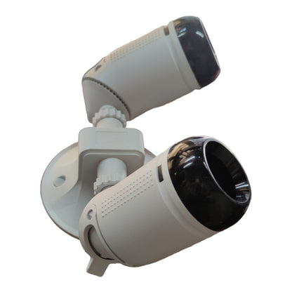 A dual-camera security light fixture with two white cylindrical cameras and black lenses, mounted on a white circular base against a plain white background.