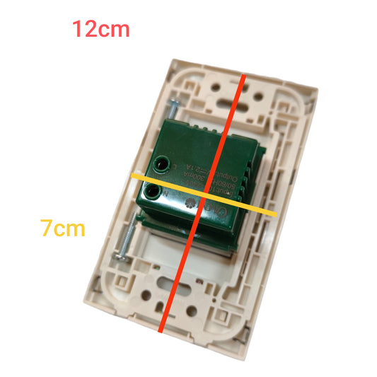 A beige wall switch plate with a green electrical component mounted in the center, overlaid with red and yellow measurement lines and text reading 12cm and 7cm to show dimensions.