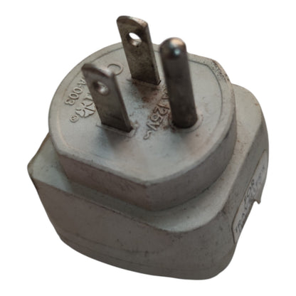 A gray plastic electrical outlet adapter plug with three metal pins, photographed on a plain white background.