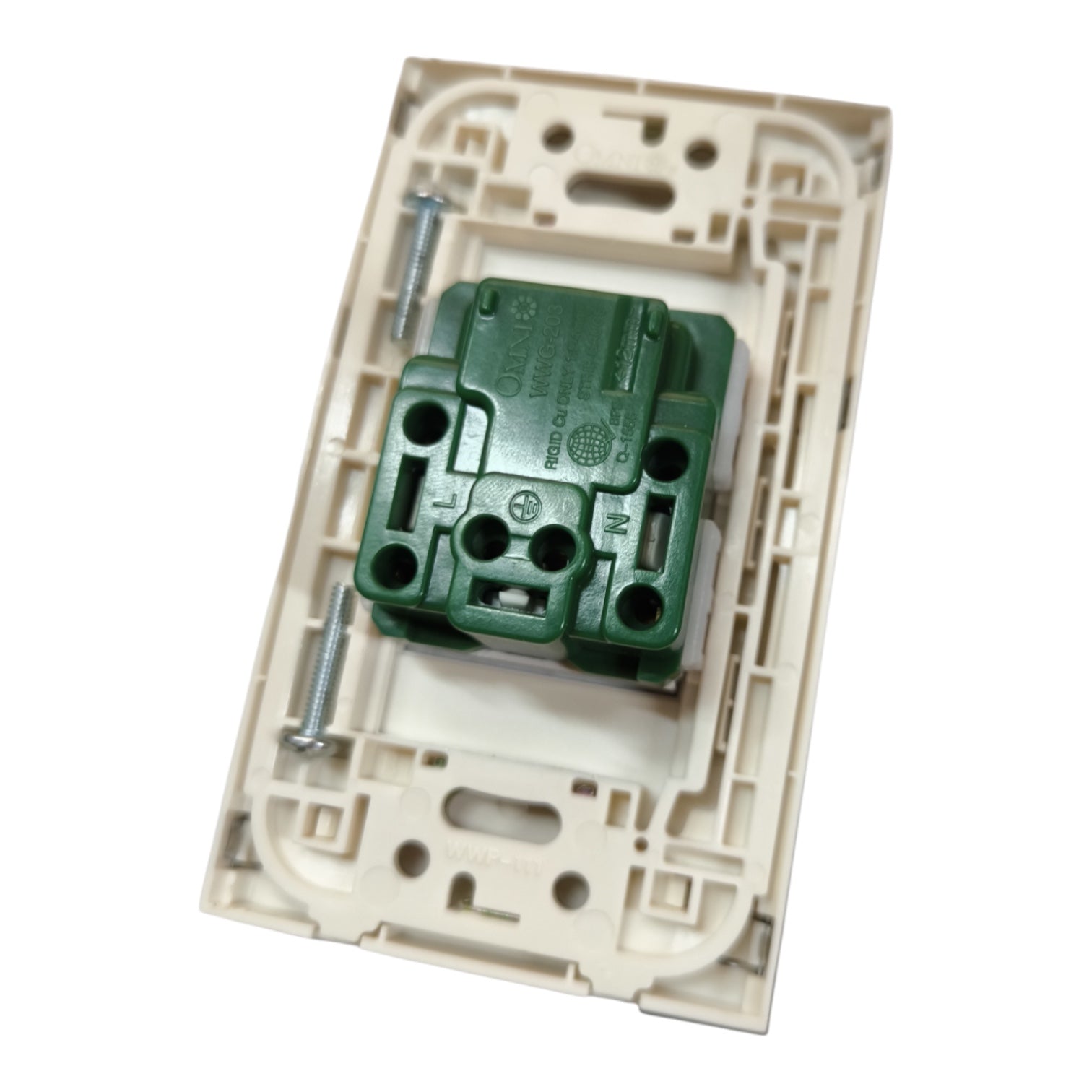 A close-up of a wall switch module showing the back side, featuring a green terminal block connector secured by two silver screws inside a beige plastic frame.