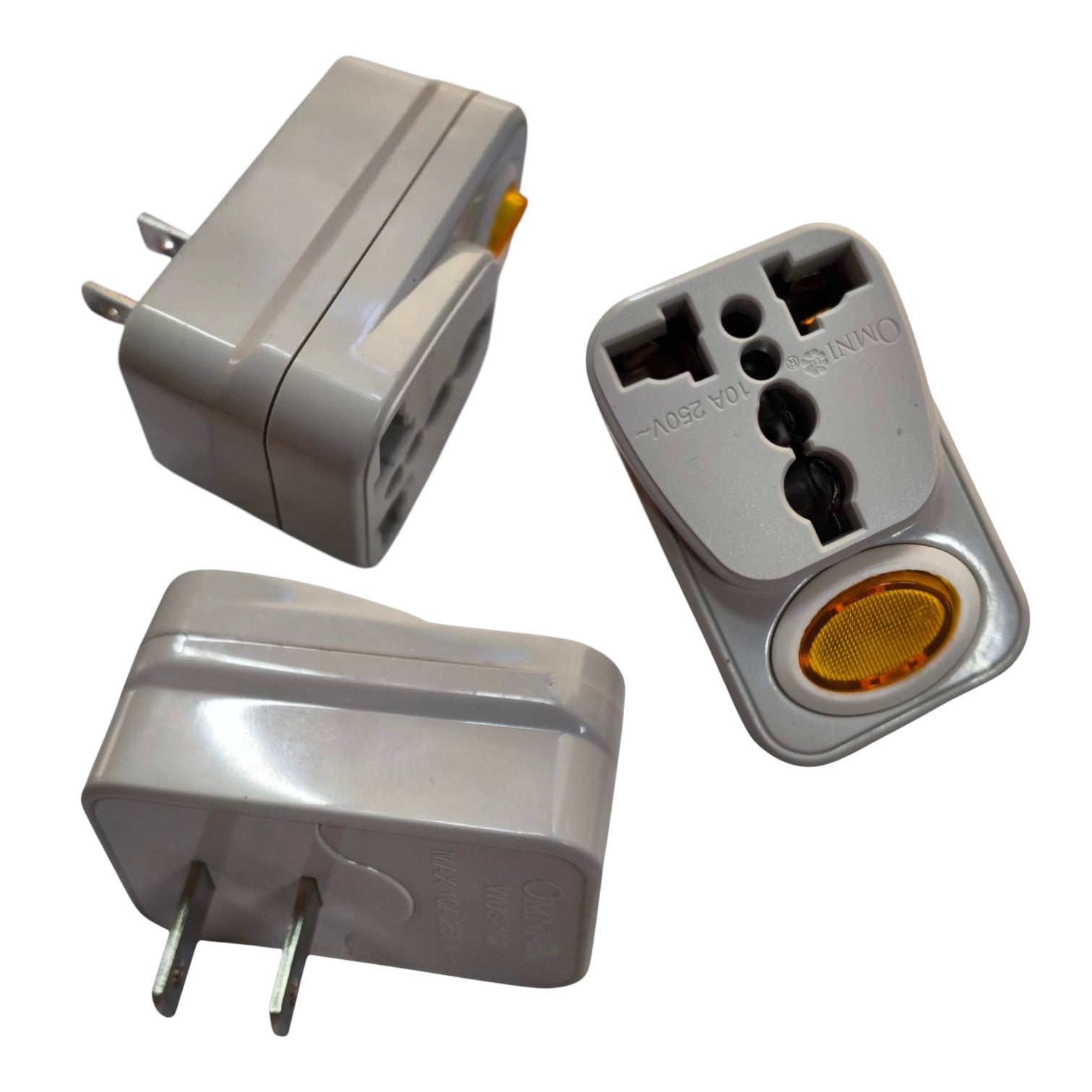 A compact gray plastic travel adapter shown from multiple angles on a white background, with two flat prongs on one side and a multi-pin plug insert on the other.