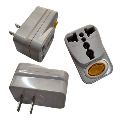 A compact gray plastic travel adapter shown from multiple angles on a white background, with two flat prongs on one side and a multi-pin plug insert on the other.