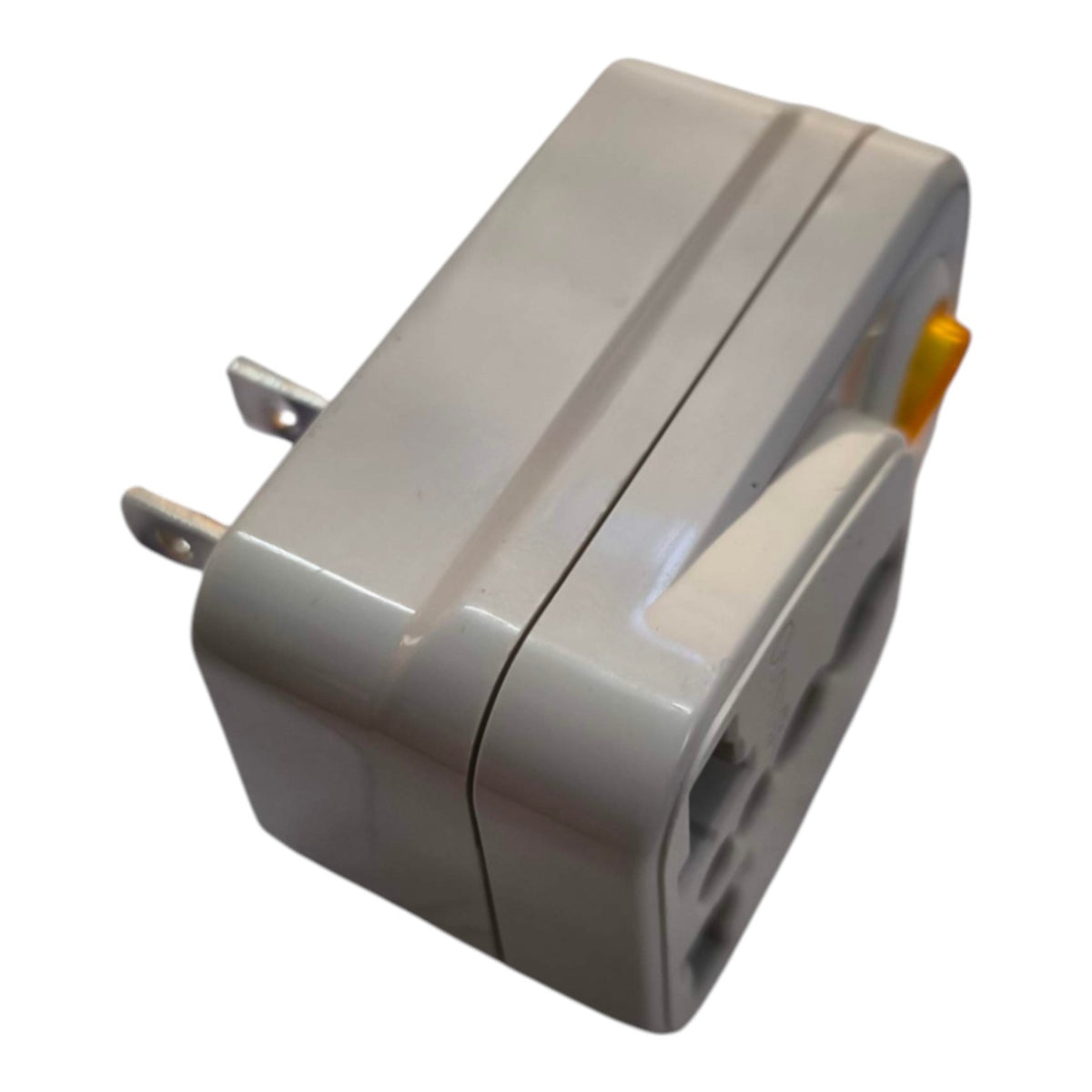 A compact gray plastic plug adapter with two metal prongs and a small orange switch, shown on a plain white background.
