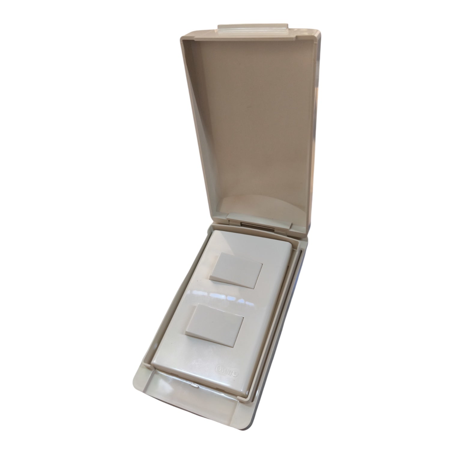An open beige plastic case containing two small square white items, photographed on a plain white background.