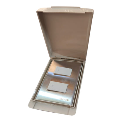 A two-button wall switch plate set in a beige plastic protective housing, shown open against a plain white background.