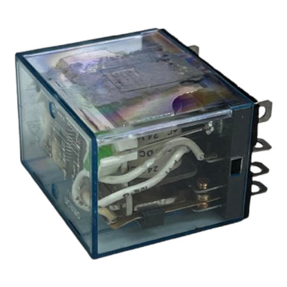 A square electrical relay with a transparent blue plastic housing, showing internal wiring and components, isolated on a white background.