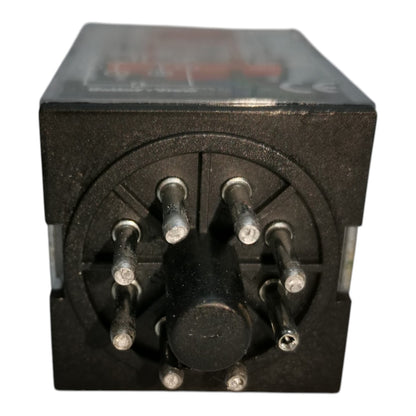 A black electrical relay or sensor module with multiple metal pins and a circular pin arrangement, photographed against a plain white background.