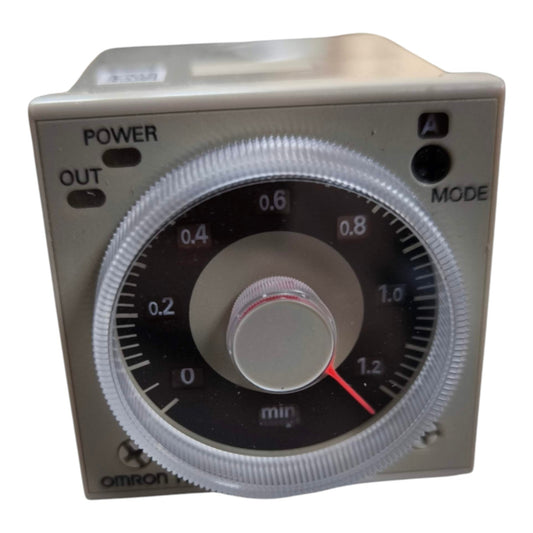An Omron timer module with a silver metal casing, a large black dial with white markings, a central silver knob, and a red pointer needle.