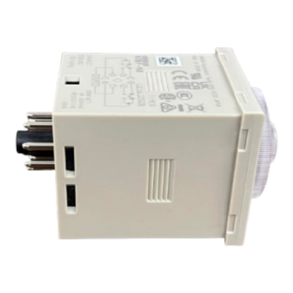 An industrial electrical contact relay or timer module with a beige plastic housing, a black multi-pin connector on the left, and a translucent white circular component on the right, shown against a plain white background.