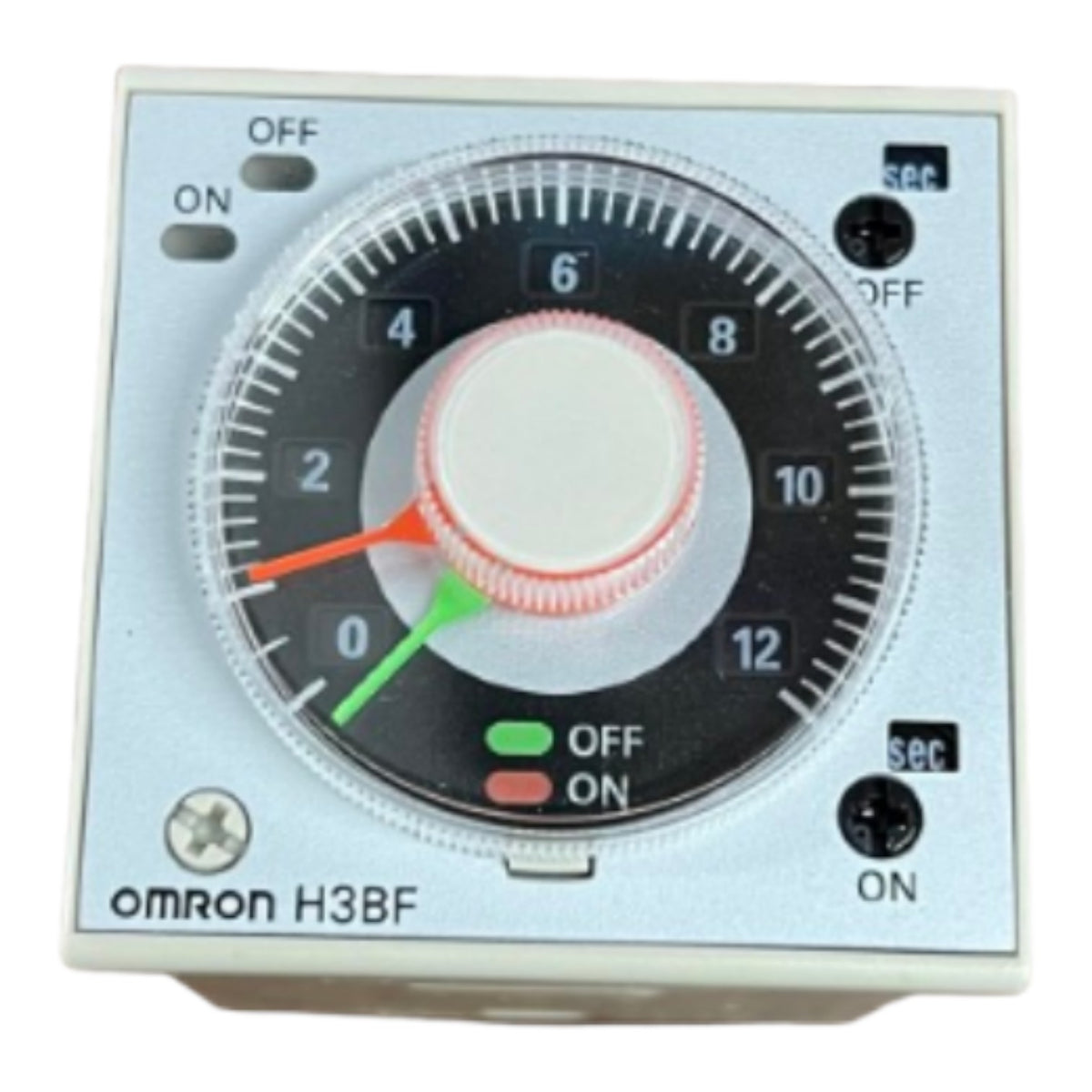 An Omron H3BF analog timer switch with a silver faceplate, black dial, white center knob, and red and green indicator needles.