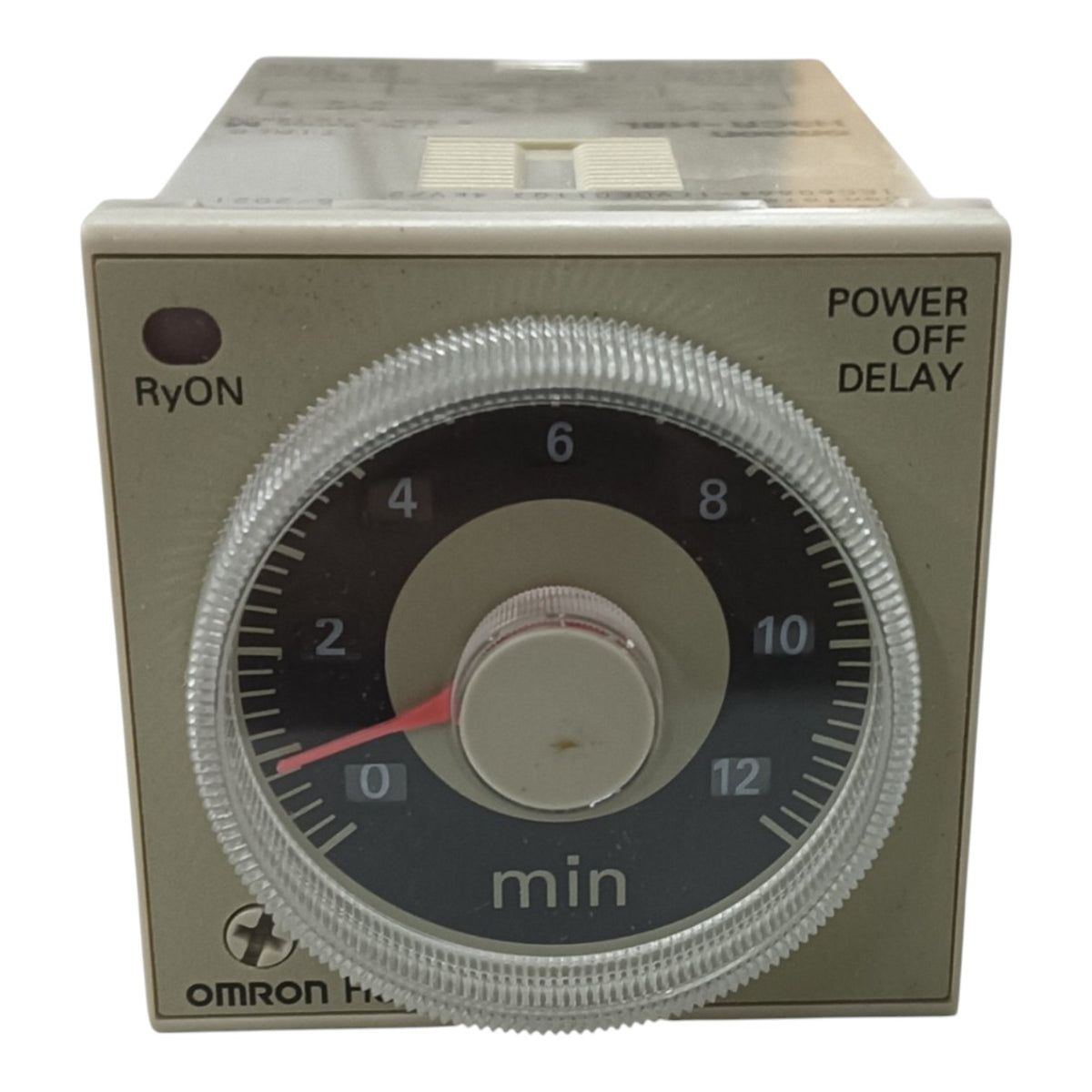 An Omron H-20 timer relay with a beige plastic housing, a clear ribbed protective cover over a black dial, and a red pointer needle.