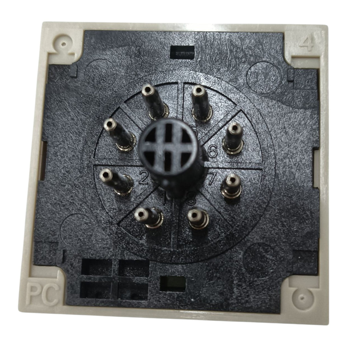 A square electrical switchback or modular backplate component with a black textured central faceplate, eight metal screw terminals arranged in a circle, and a beige plastic outer frame with numbered corners 1 through 4.
