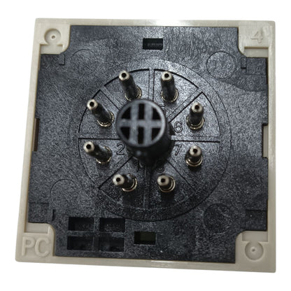 A square electrical switchback or modular backplate component with a black textured central faceplate, eight metal screw terminals arranged in a circle, and a beige plastic outer frame with numbered corners 1 through 4.
