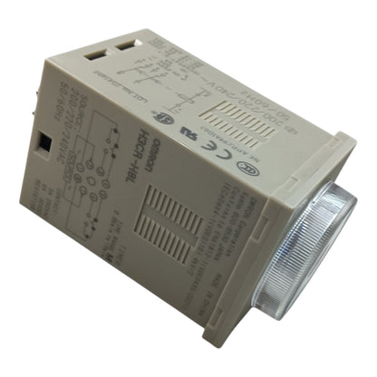 An Omron HSCR-HBL electrical contact module, model 70-00-002-24010-4, featuring a beige plastic housing with printed technical specifications and a clear ribbed lens over the contact point, shown on a white background.