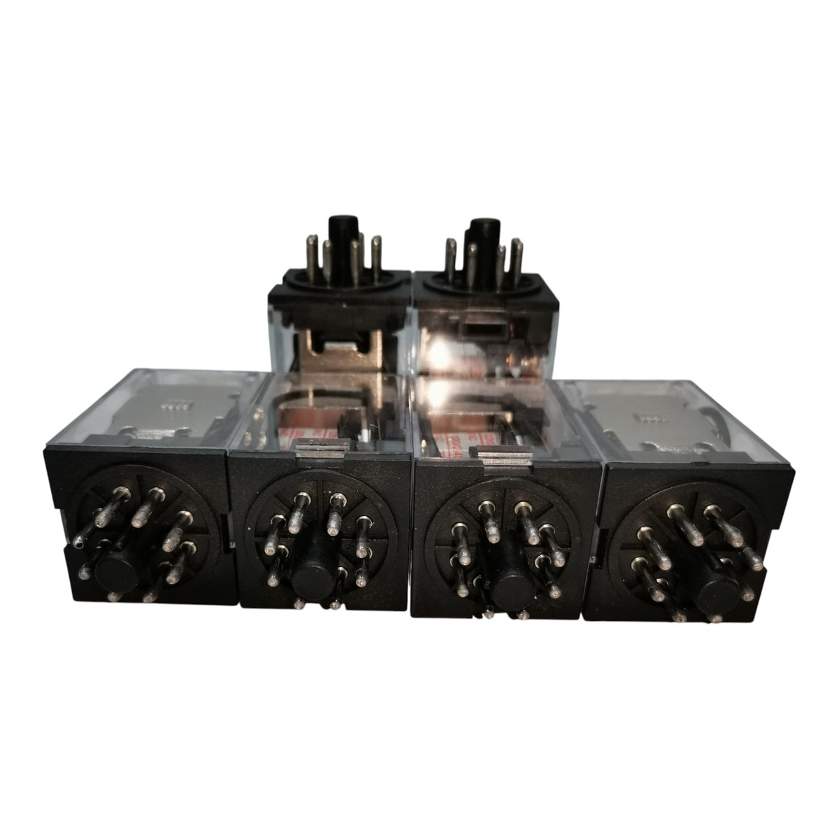 Four black electronic components with transparent tops and multiple metal pins, arranged in a row on a white background.