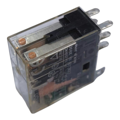 A small electrical relay with a transparent plastic housing, black internal components, copper-colored terminal screws, and silver metal pins, shown on a plain white background.