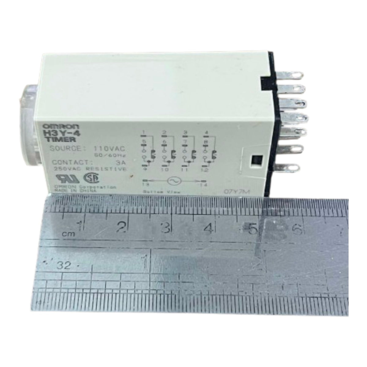 An Omron H3Y-4 AC contact timer relay shown next to a metal ruler for scale, on a plain white background.