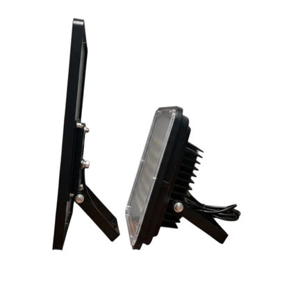 A black LED floodlight shown from two angles: a side profile view on the left and a front-three-quarter view on the right, displaying its heat sink fins, clear lens, and mounting bracket against a plain white background.