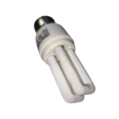 A used CFL compact fluorescent light bulb with a white plastic body, two visible glass tubes, and a silver metal screw base, shown on a plain white background.