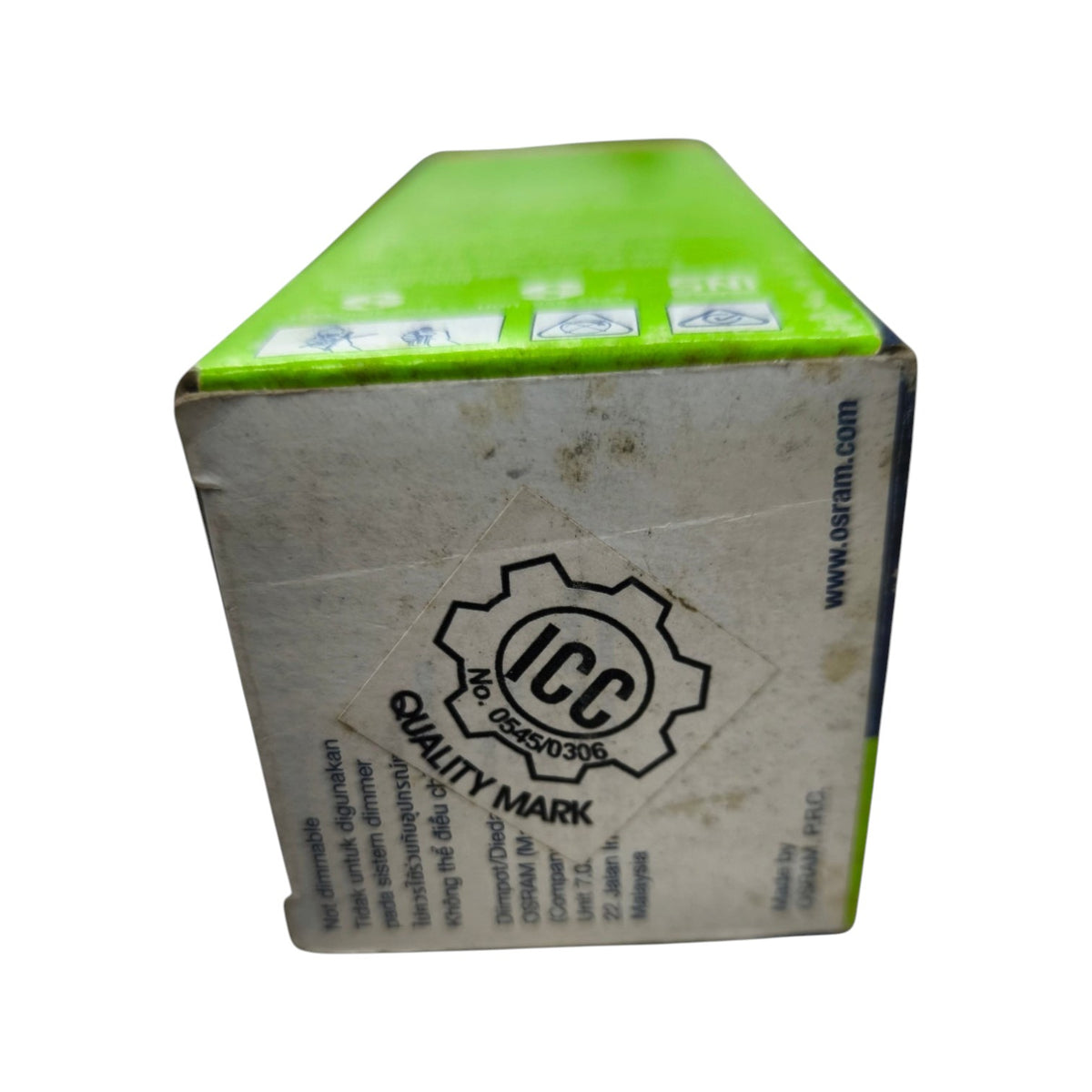 A cardboard box for O2OOM brand food packaging, featuring a bright lime green top panel and a heavily scuffed off-white side panel with the black ICC Quality Mark logo.