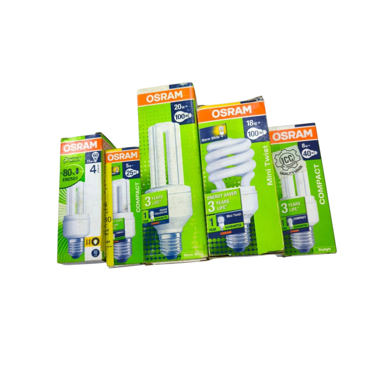 Four OSRAM compact fluorescent light bulbs in their retail packaging, arranged in a group on a plain white background. The packages show different bulb types and wattages including Compact, Compact 3-Way, and Mini Twist.
