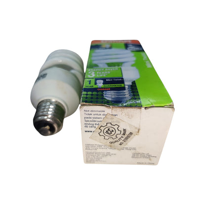 A compact fluorescent light bulb with a silver metal base shown next to its green and white retail packaging box on a plain white background.