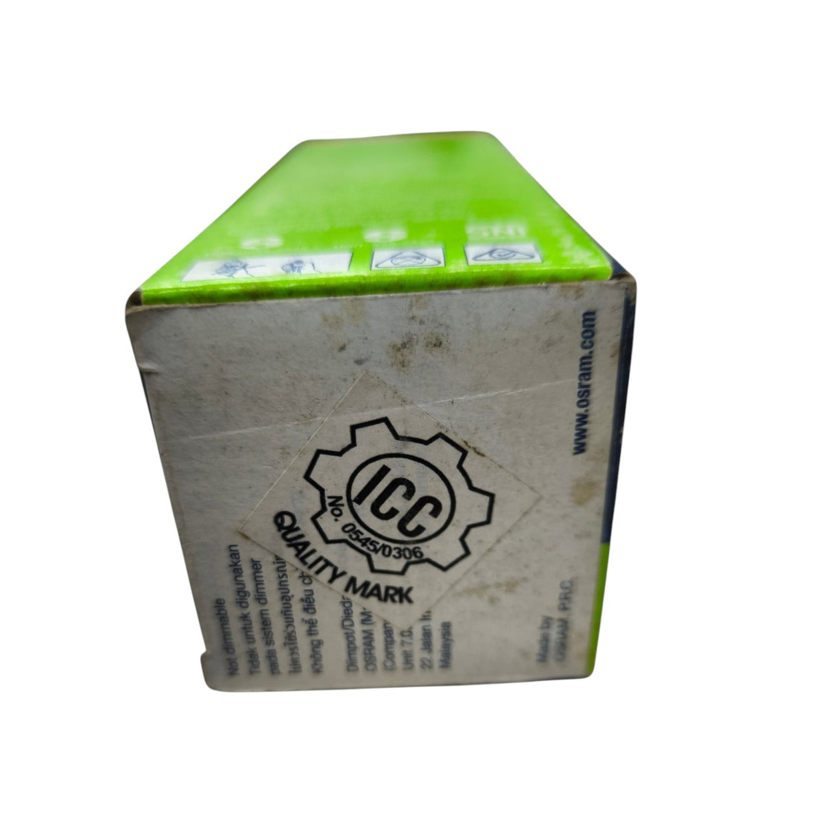 A cardboard box with a bright lime green top and a dirty off-white side panel featuring a black ICC Quality Mark logo and website text.