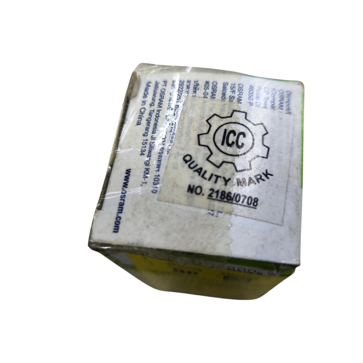 A small square cardboard box wrapped in clear tape, showing a large ICC Quality Mark label on the top. The box appears slightly skewed and is photographed against a plain white background.